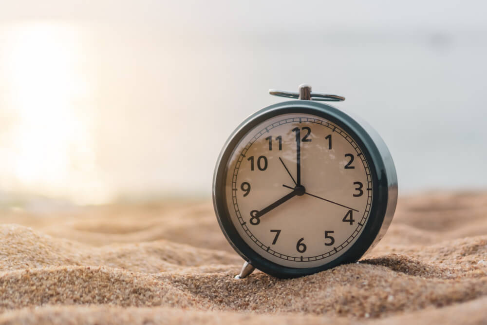 selective-focus-alarm-clock-with-nature-background